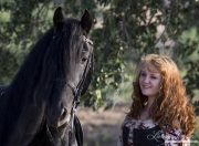 girl and purebred Black Friesian stallion in Ojai, CA