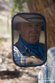 Flitner Ranch, Shell, WY - Cowboy's reflection in old rearview mirror of truck