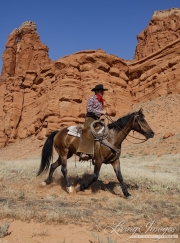 Flitner Ranch, Shell, WY - cowboy and horse in front of red cliffs