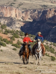 Flitner Ranch, Shell, WY - cowboy and cowgirl ride hand in hand