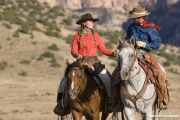 Flitner Ranch, Shell, WY - cowboy and cowgirl riding hand in hand