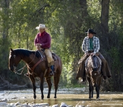 Flitner Ranch, Shell, WY - two cowboys stand in stream