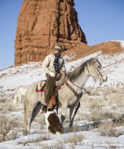 Flitner Ranch, Shell, WY, horses in winter, cowboy on horse with dog in front of rock formation