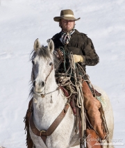 Flitner Ranch, Shell, WY, horses in winter, cowboy on horse holding halters