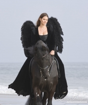 Black Angel on black Friesian stallion on the beach in Ojai, CA